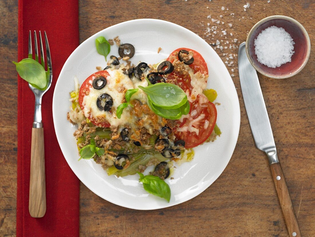 Leek and tomato gratin with olives and basil