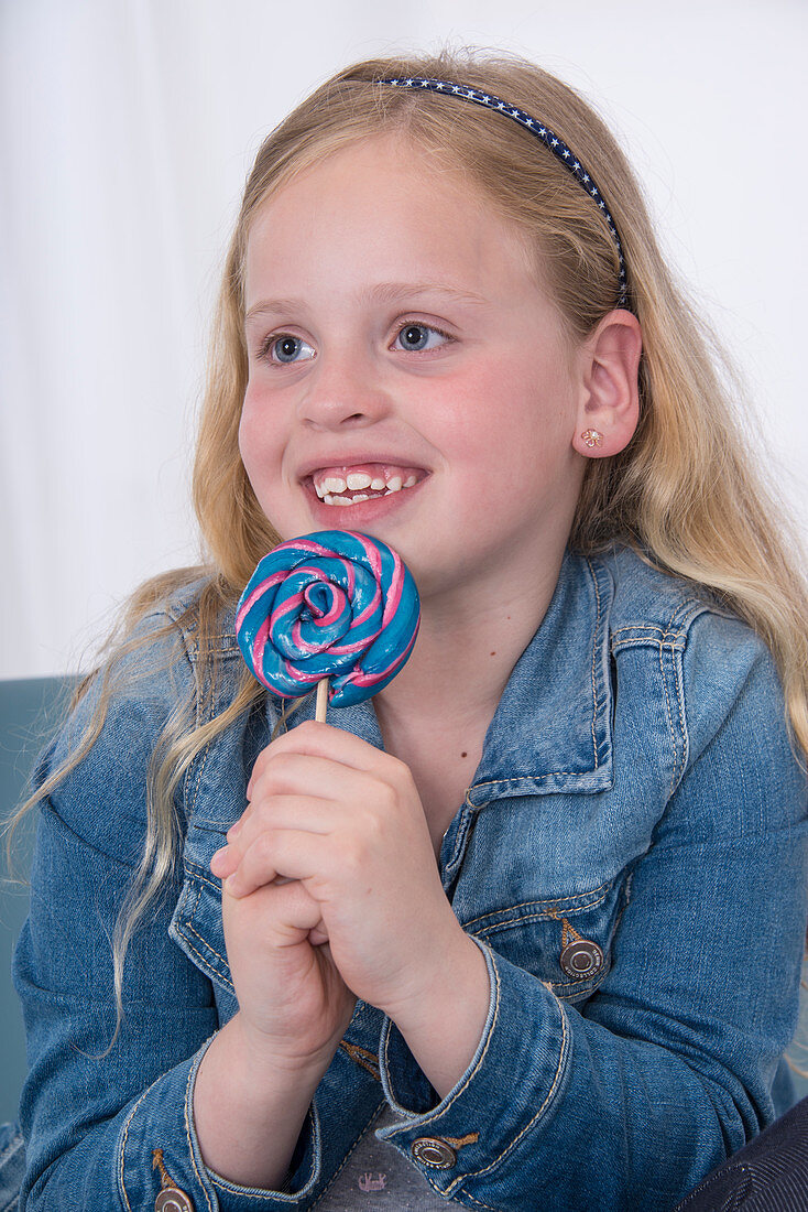 Girl holding lolly pop