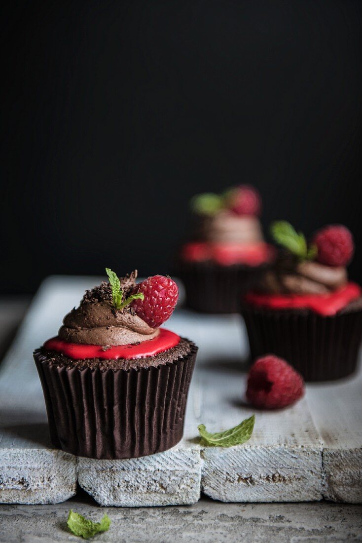 Dark chocolate and raspberry cupcakes with mint leaves