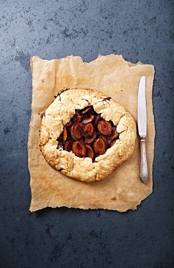 A rustic plum galette on baking paper