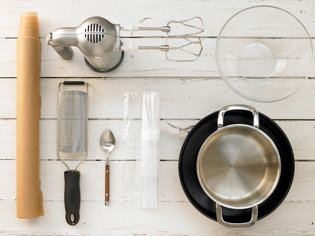 Kitchen utensils for making a cheesecake with a biscuit base