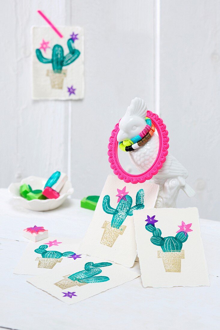 Cards printed with cactus motifs arranged on cockatoo figurine