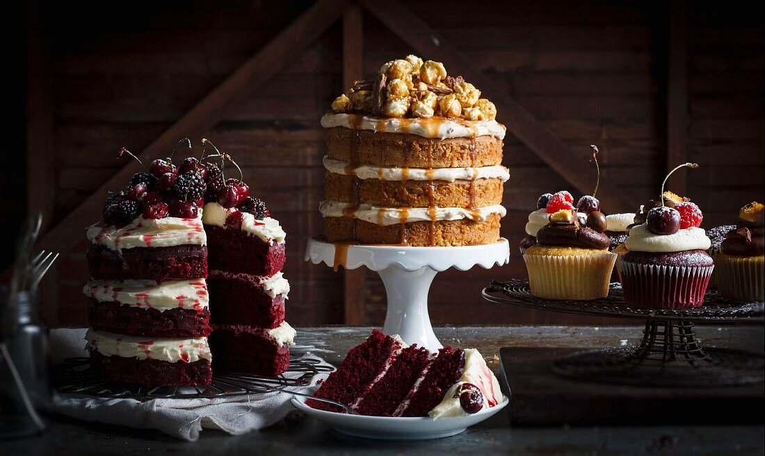 Assorted layered cakes and cupcakes