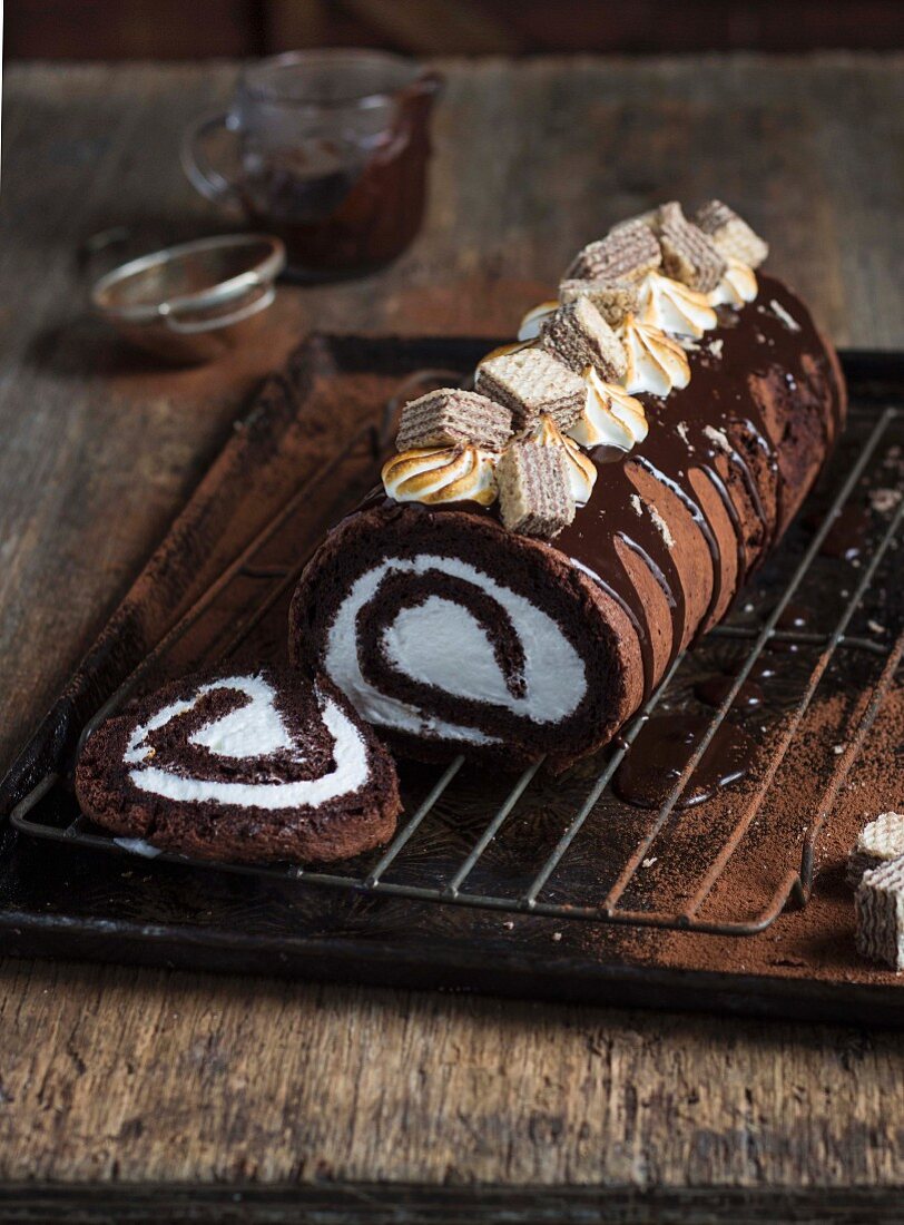 A chocolate Swiss roll with marshmallows and wafer biscuits