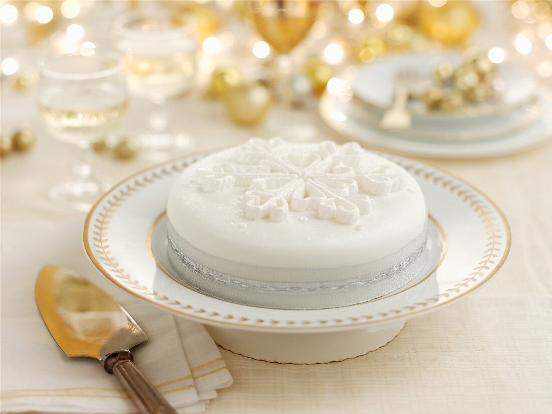 A white Christmas cake on a festively laid table