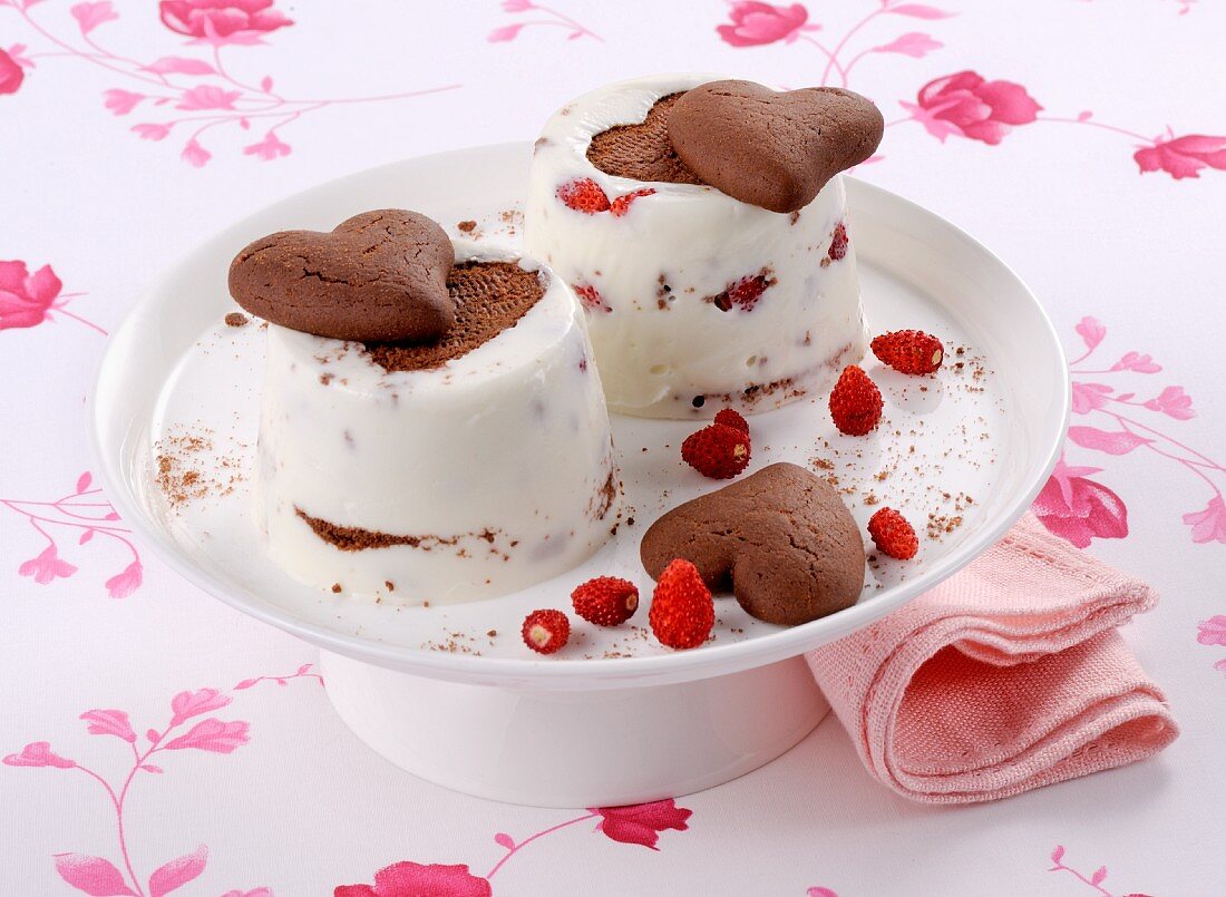 A woodland strawberry dessert with heart-shaped chocolate biscuits tipped out onto a plate