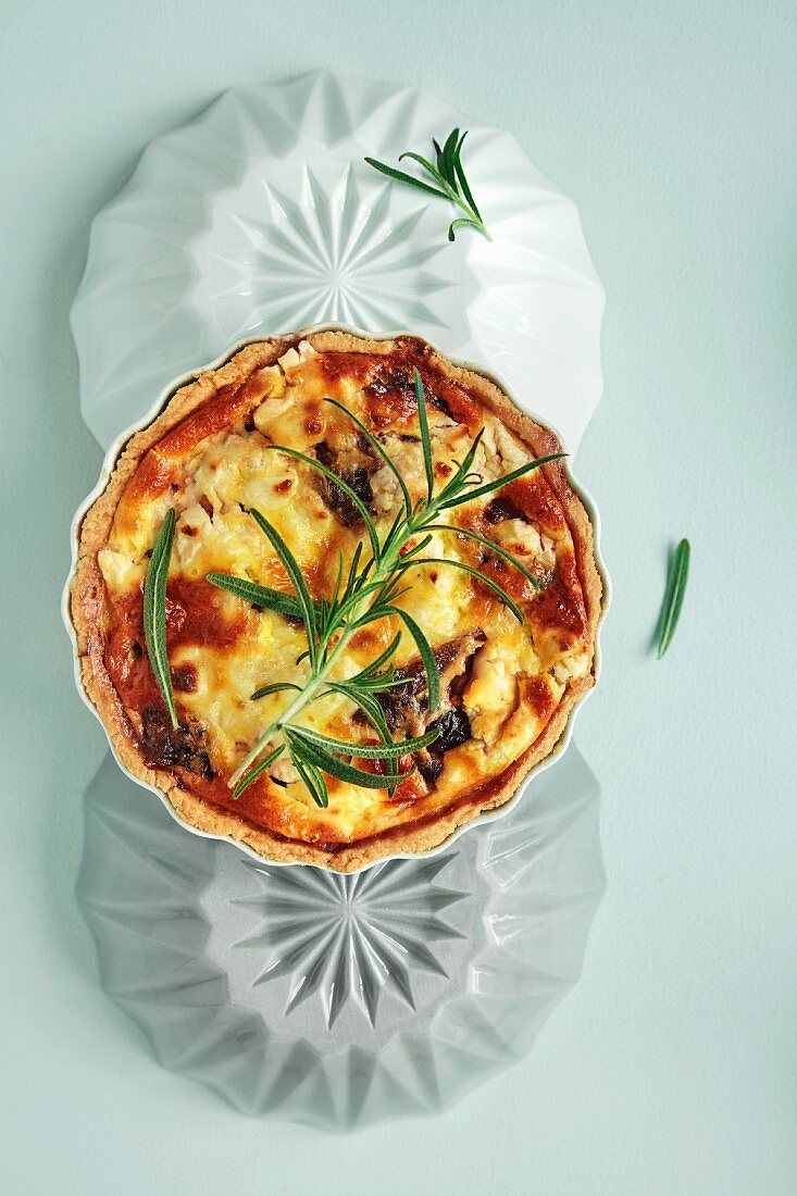 A small quiche with feta, crème fraiche, and rosemary