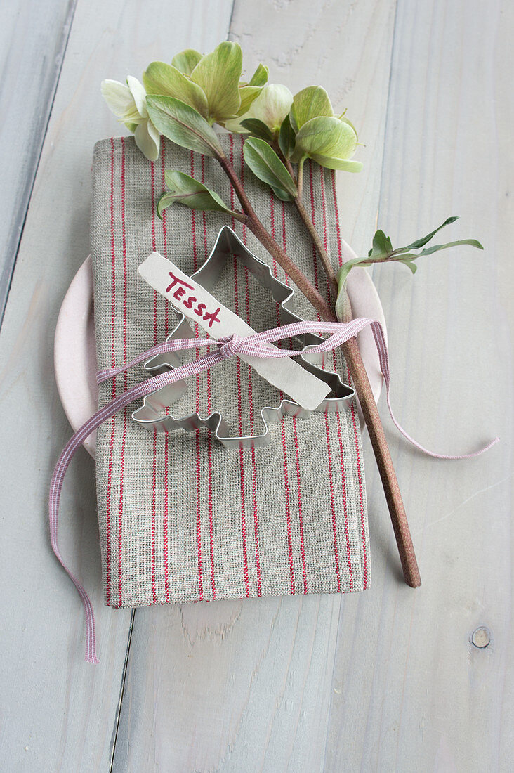 Christmas-tree pastry cutter and hellebore on napkin