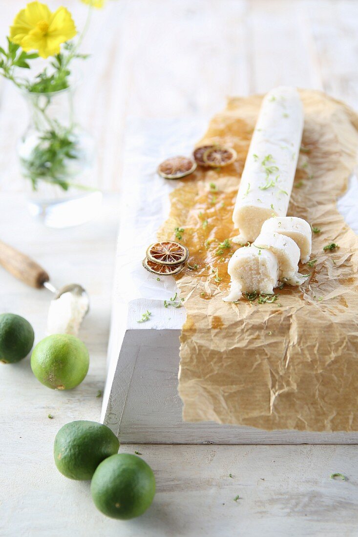 A roll of vegan coconut butter with dried lime slices