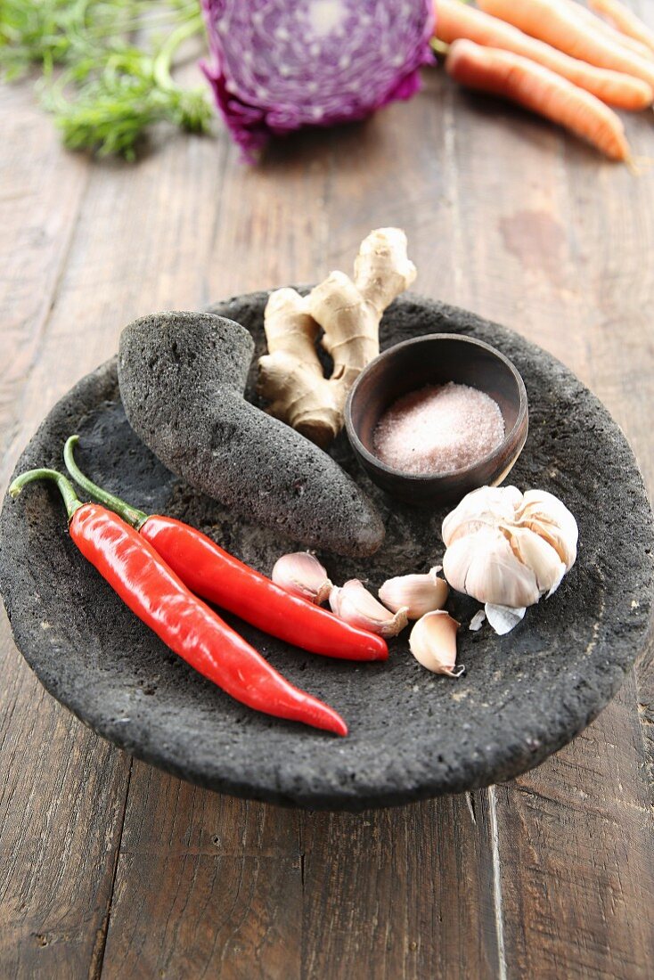 Chilli, garlic and ginger in a stone mortar with pestle