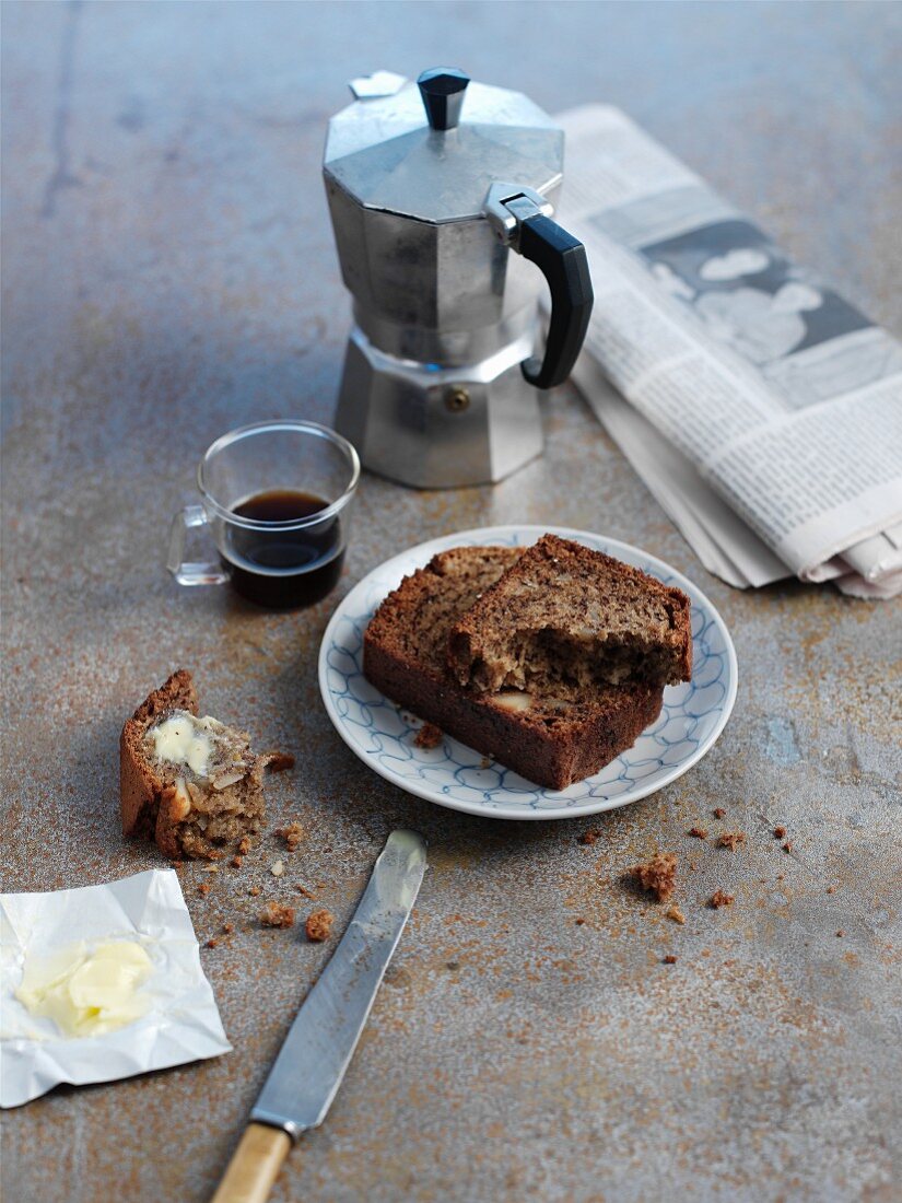 Breakfast with banana bread, espresso and a newspaper