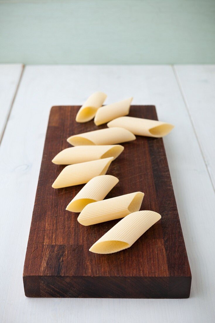 Penne rigate on a wooden board