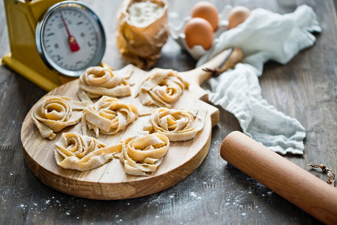 Homemade tagliatelle on a wooden board