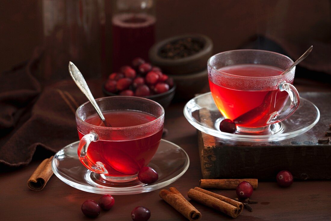 Two cups of hot cranberry tea with spices