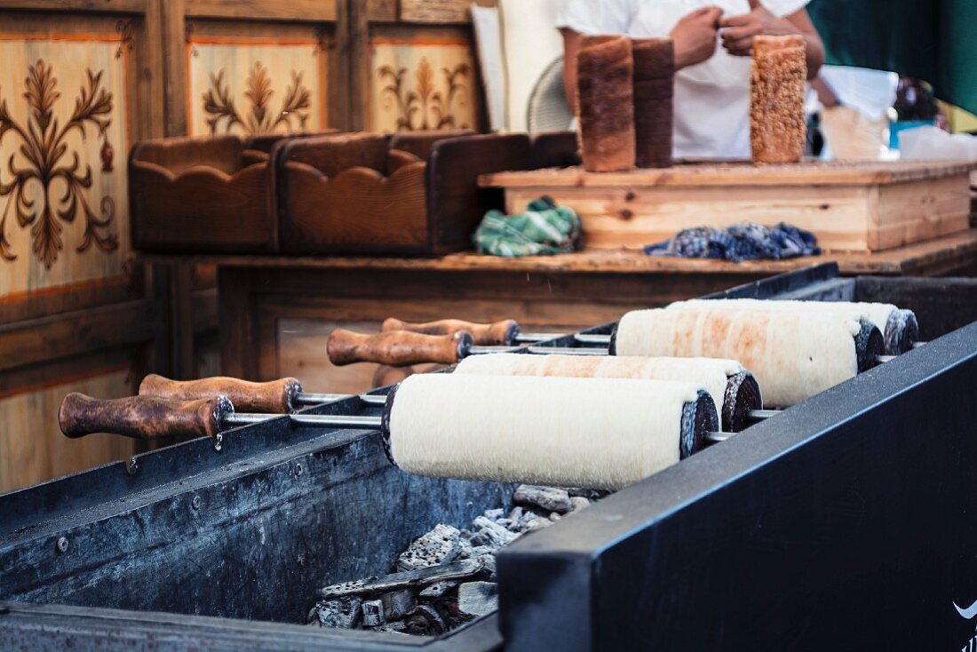 Kürtőskalács (or kurtos kalacs) chimney cake, a typical dessert from Budapest, on a charcoal grill