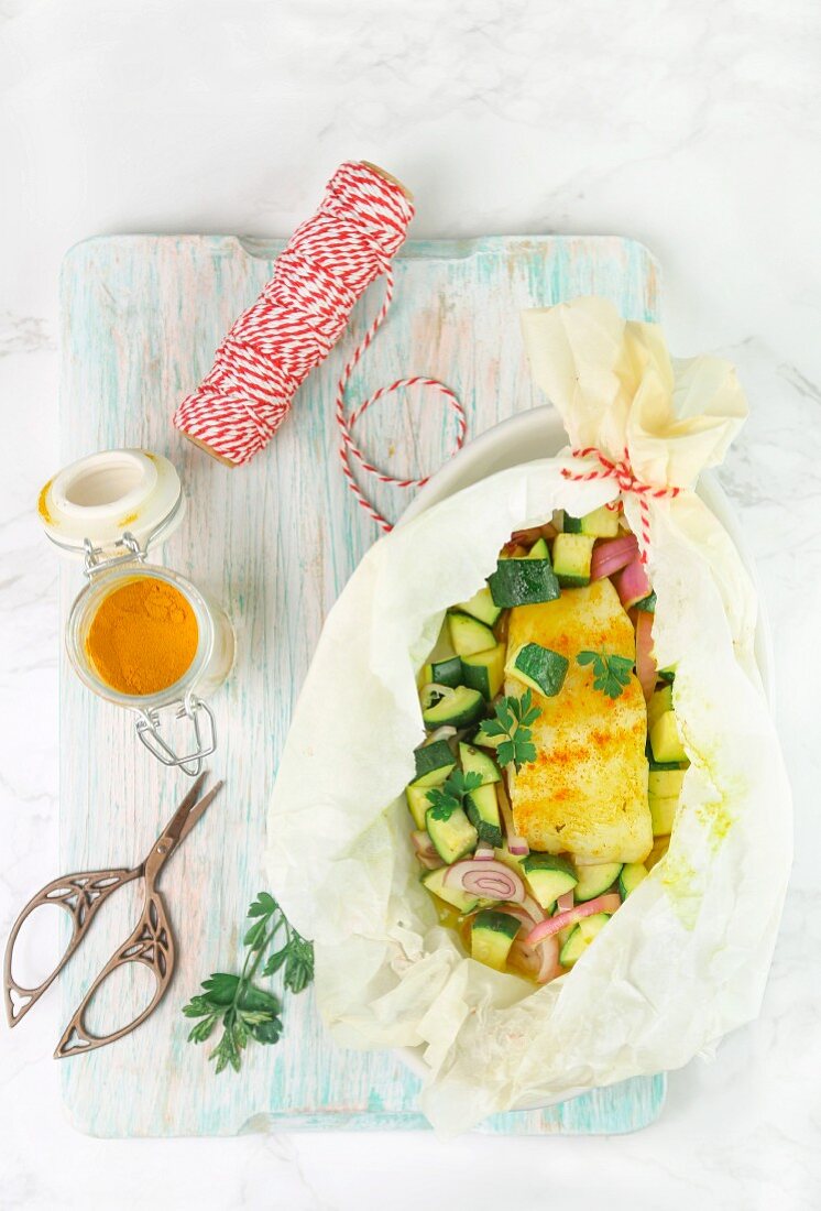 Cod with turmeric and courgette in parchment paper