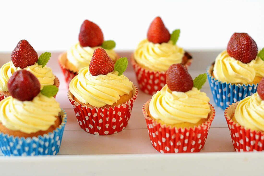 Cupcakes mit Buttercreme und Erdbeeren
