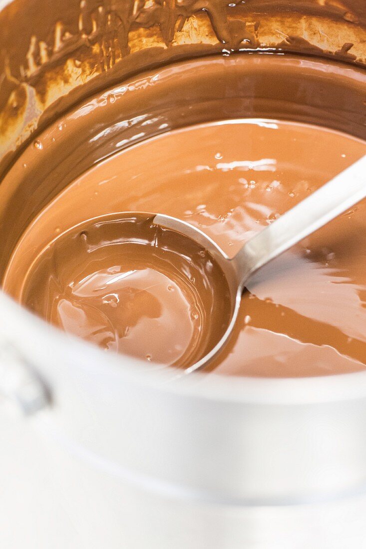 Chocolate sauce in a saucepan with a ladle