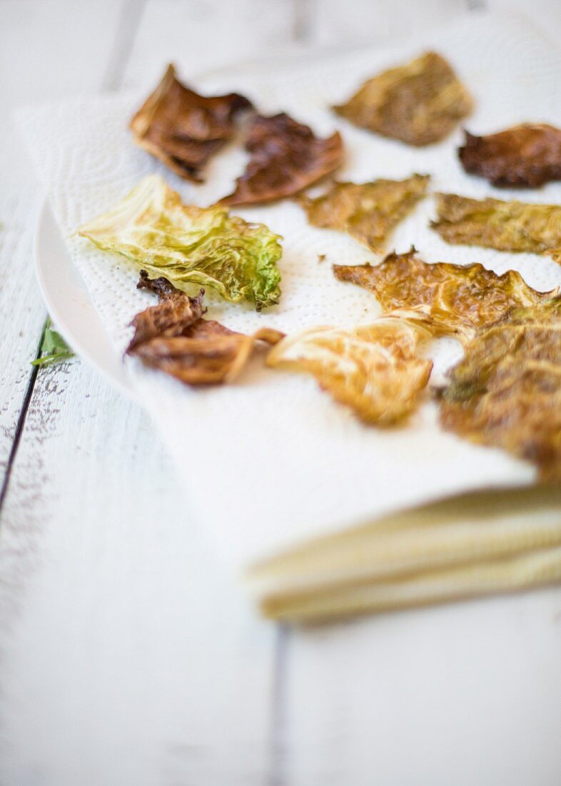 Savoy cabbage crisps on a sheet of kitchen roll