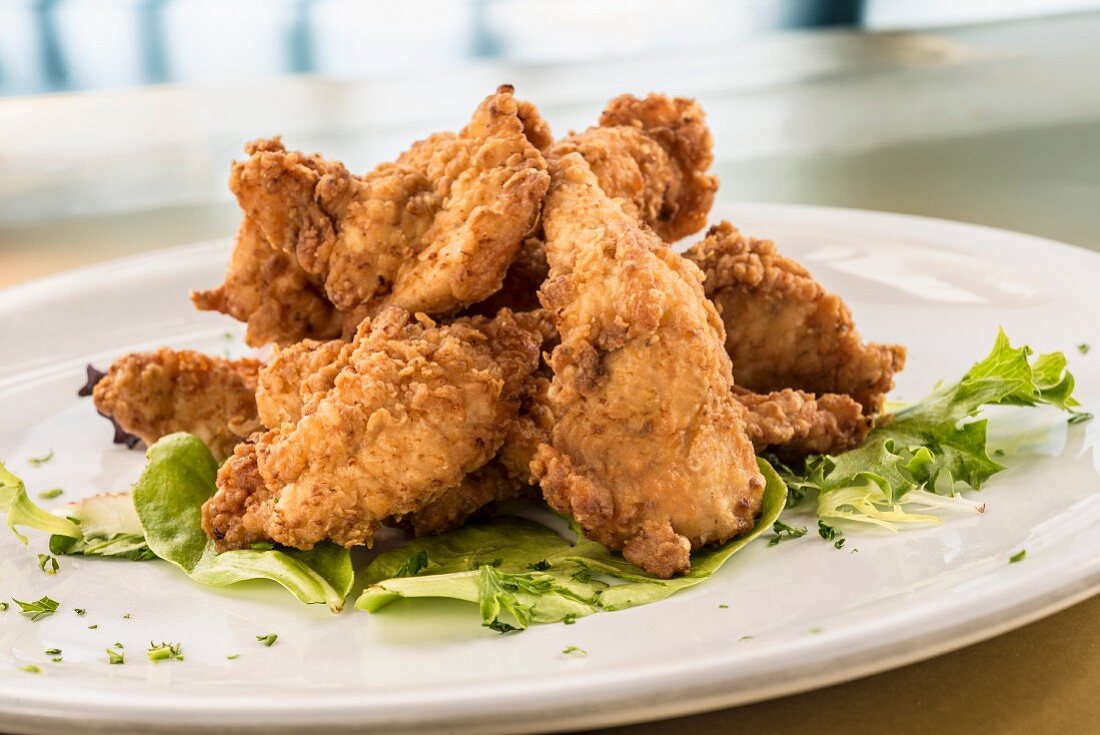 Fried chicken tenders on lettuce