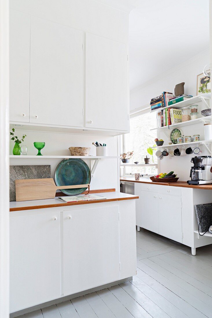 Board floor in white Scandinavian kitchen