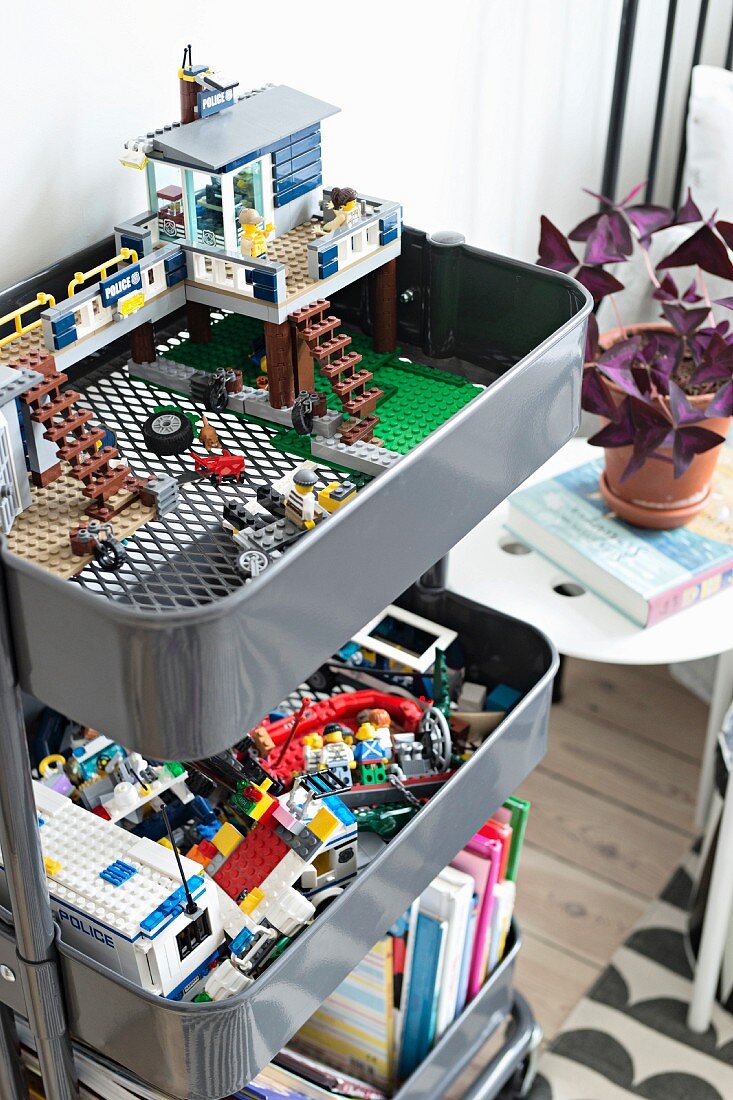 LEGO bricks and books in metal trays