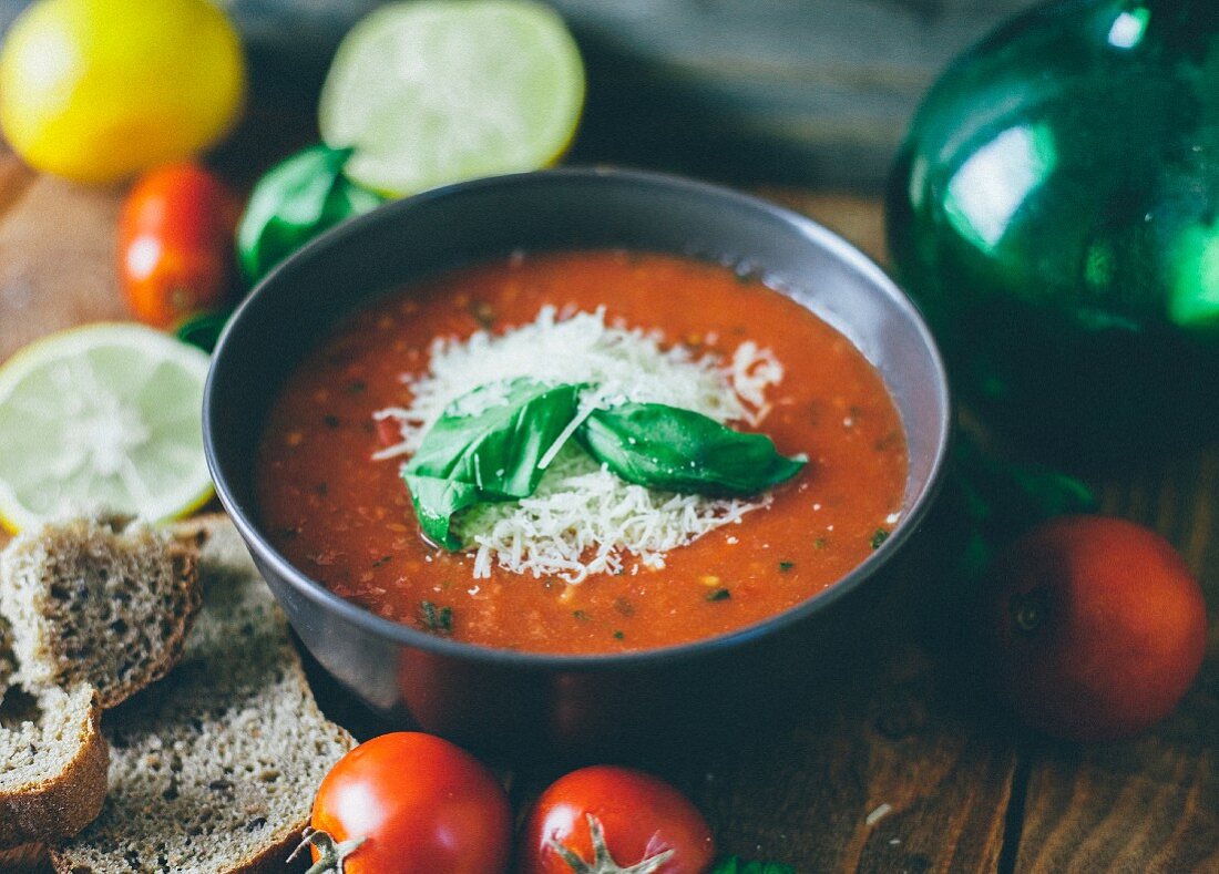 Tomato soup garnished with grated cheese and basil