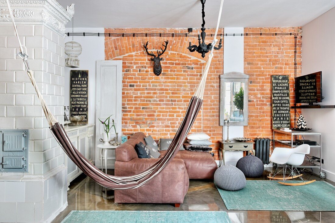 Hammock, concrete wall and tiled stove in living room