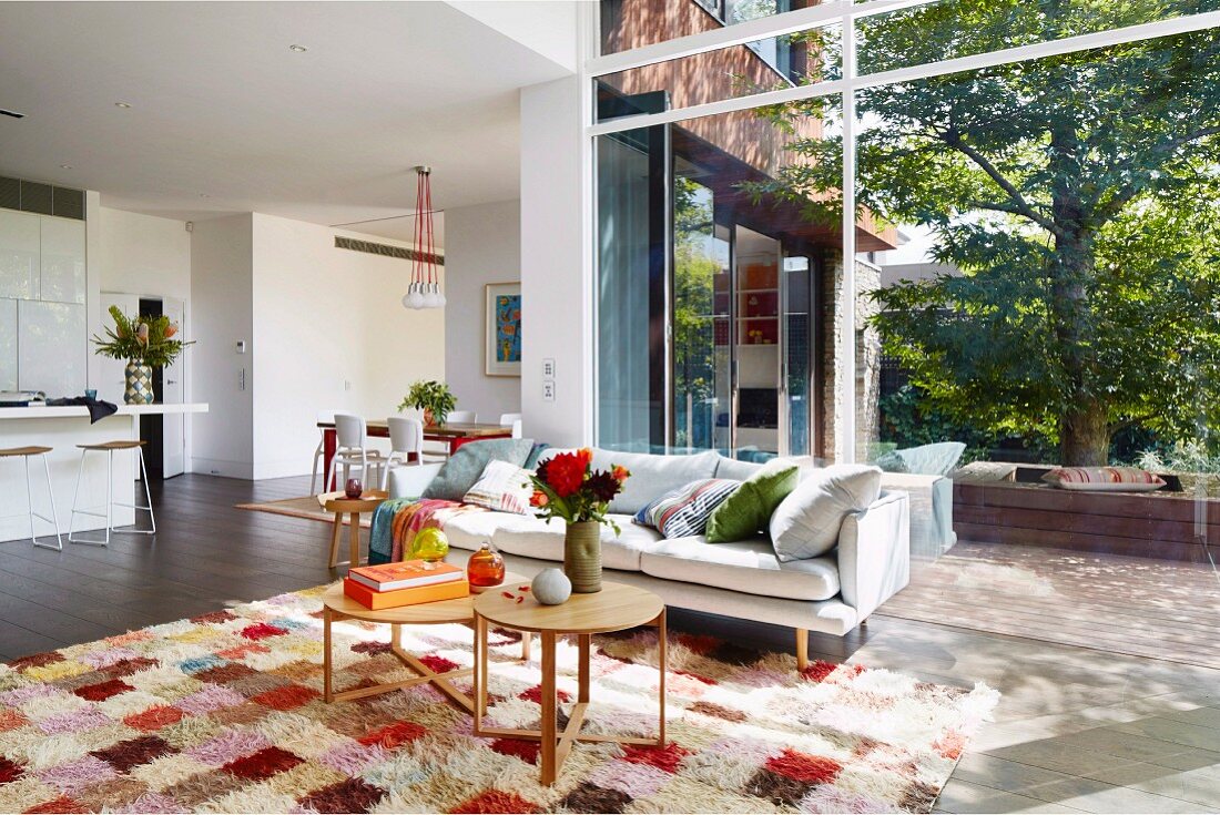 Modern open living room with window front to the garden