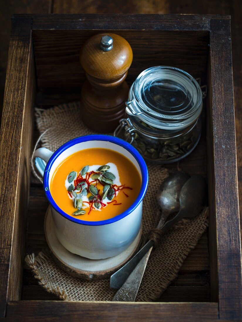 A bowl of vegan pumpkin soup with coconut milk and saffron