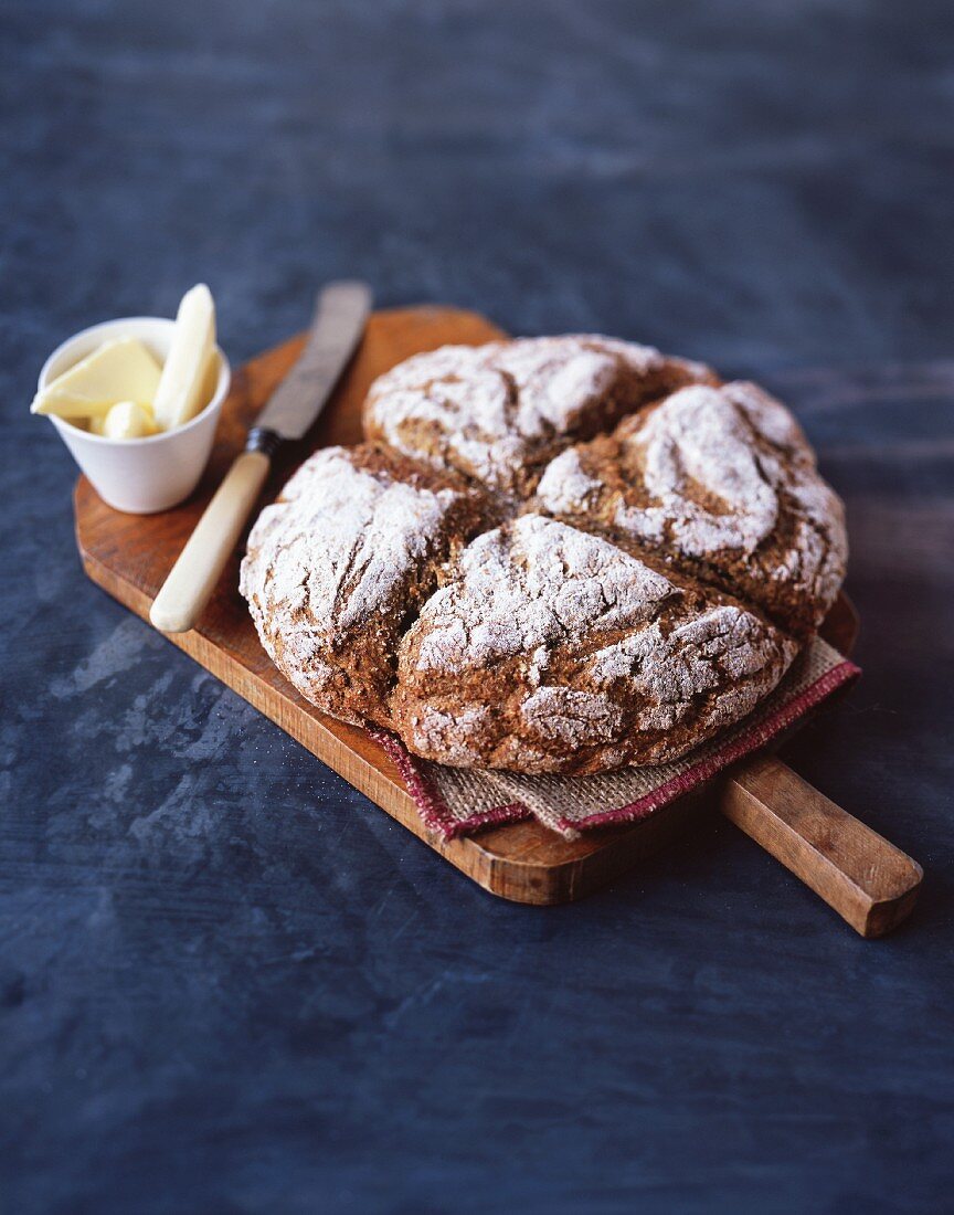 Soda bread and butter on a wooden board