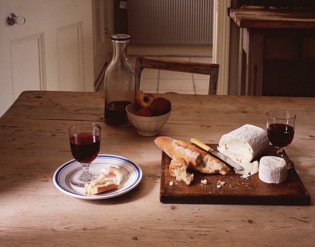 Bread, cheese and wine on a wooden table