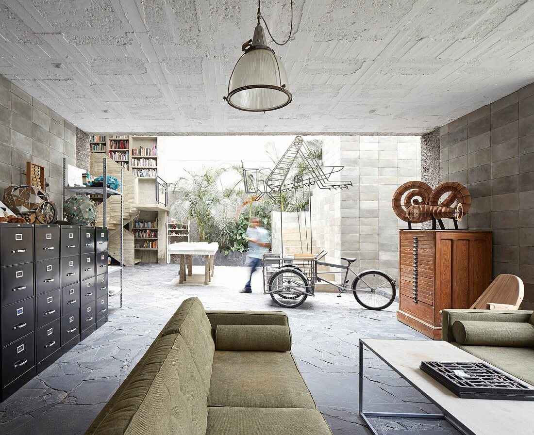 Vintage furniture in open-plan interior of concrete house