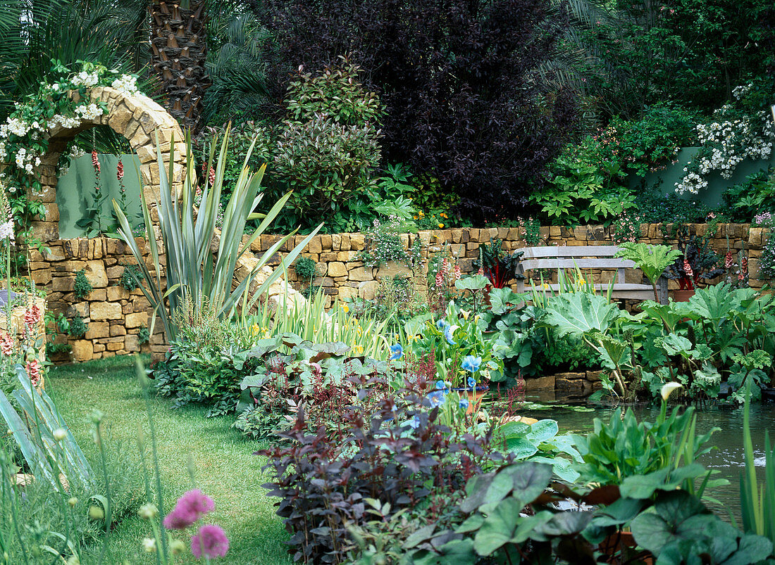 Pond in the garden with natural stone wall