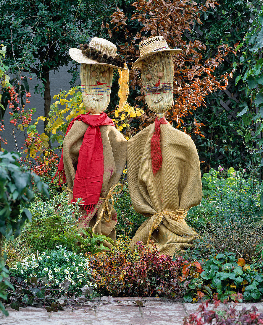 Scarecrows made of straw brooms, linen bags, walnuts and peppers