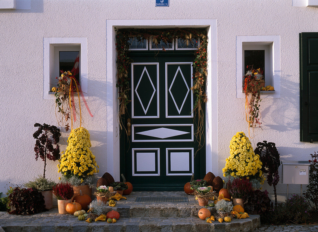 House entrance with: Chrysanthemum pyramids, Cucurbita