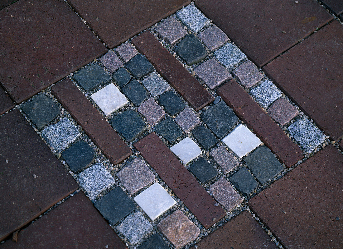 Mosaic of different colored small paving stones