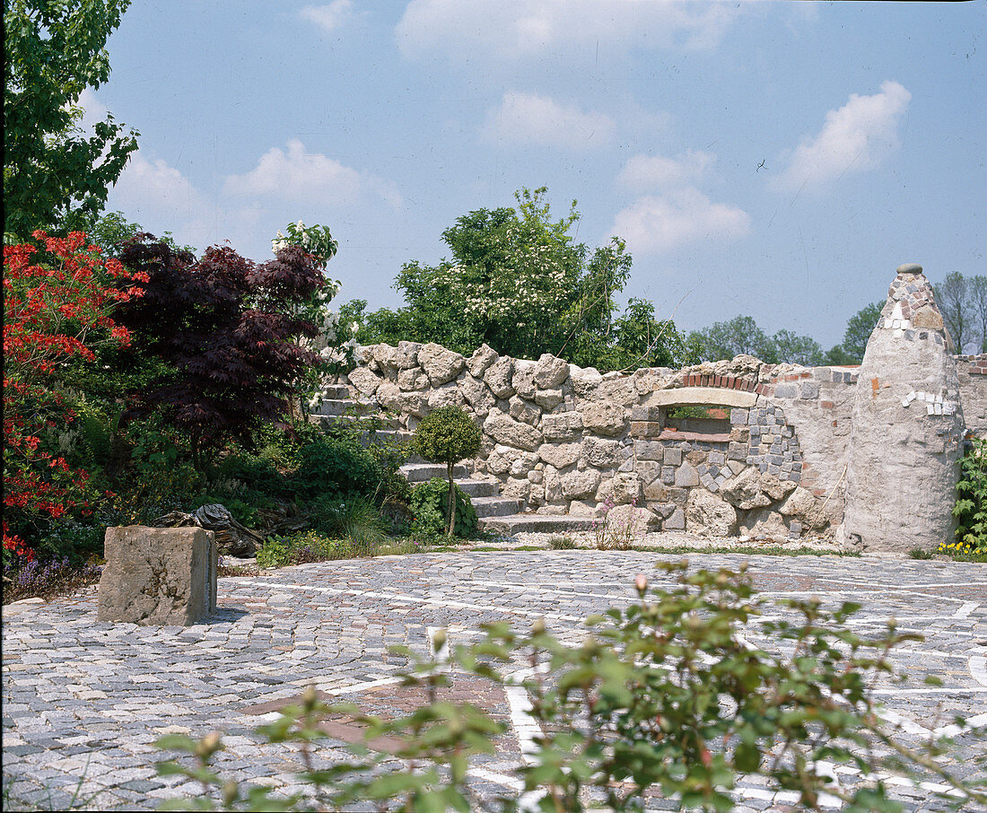 Garden with labyrinth mosaic and oriental wall