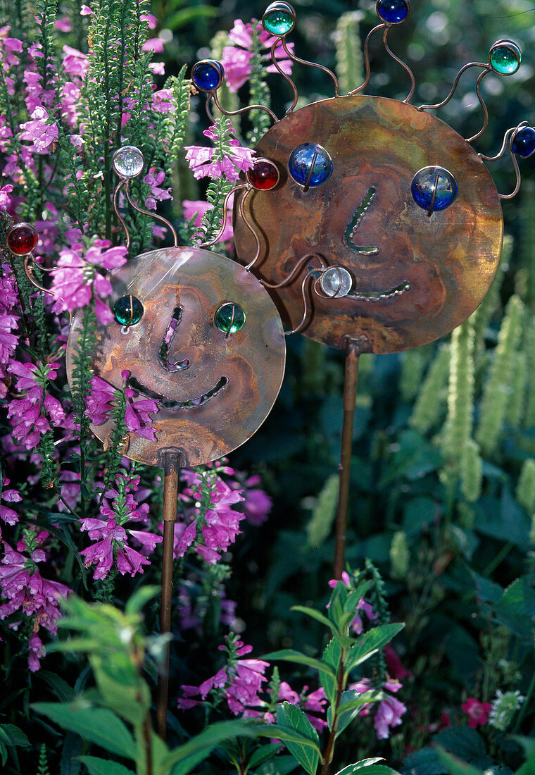 Funny faces made of copper and glass balls