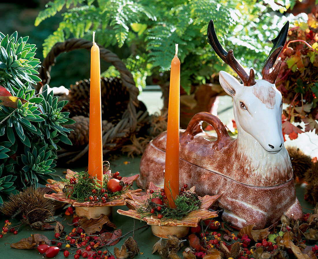 Autumnal decoration with deer figure and candles