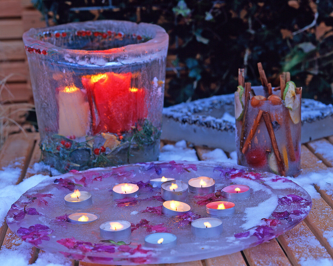 Ice lantern with frozen leaves and berries