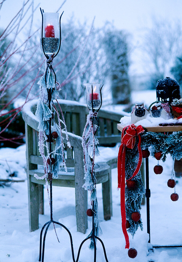 Decorated candlestick, table in hoarfrost and lanterns