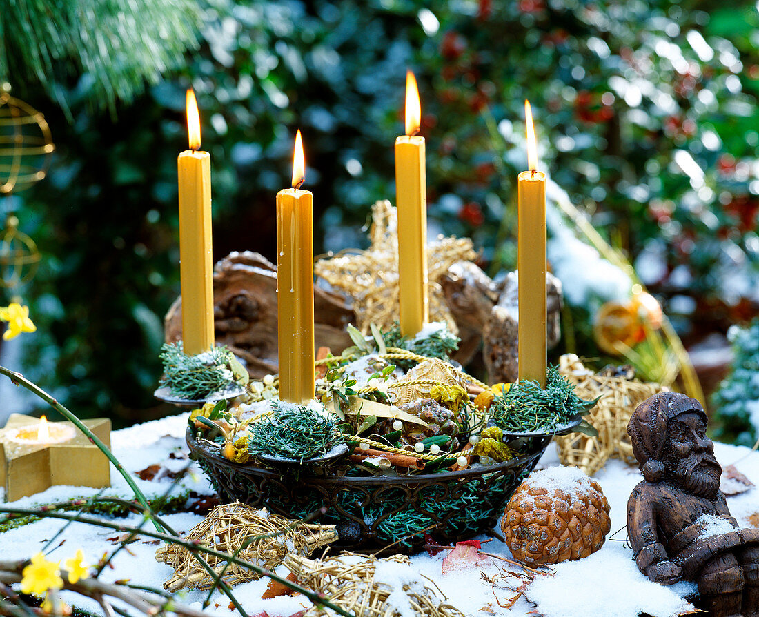 Advent basket made of iron with 4 gold candles filled with Cupressus (cypress branches)
