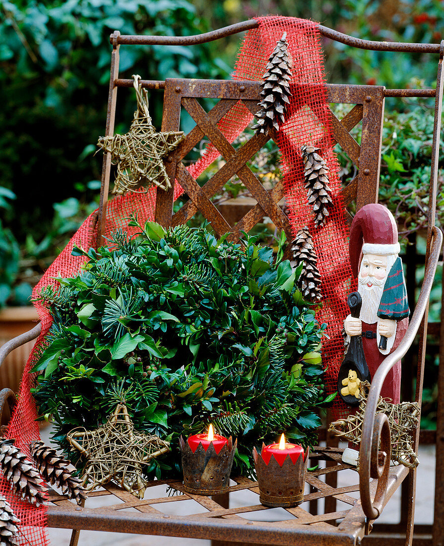 Wreath made of various branches: Spruce, boxwood, hedera, holly, privet, lanterns