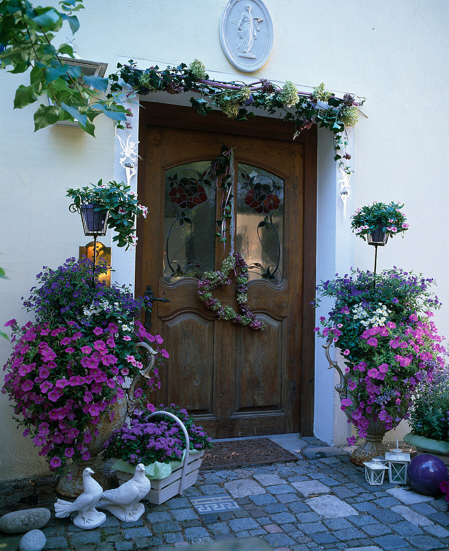 House entrance with summer ornaments, Petunia, Solanum