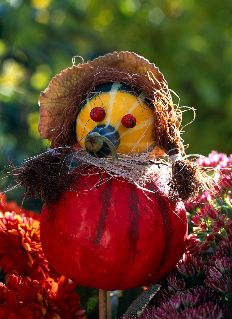 Pumpkin woman made of ornamental pumpkins and rose hips
