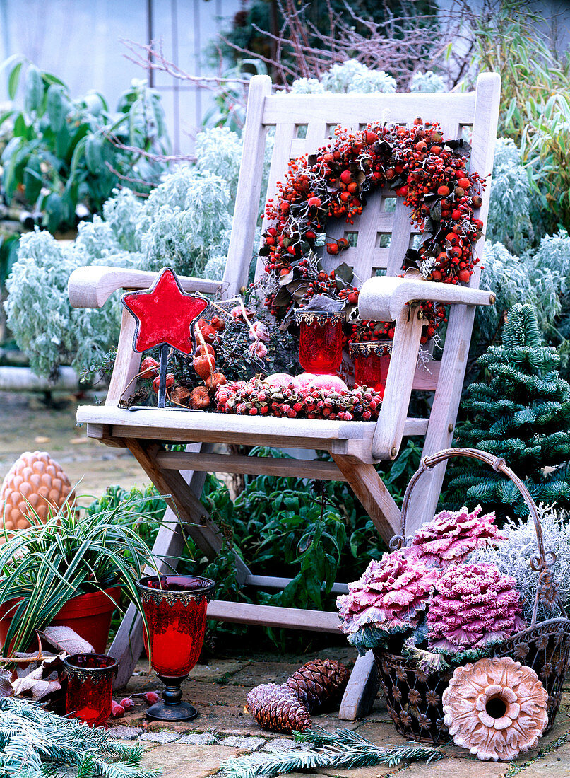 Wooden chair with roses wreaths, physalis, basket with brassica