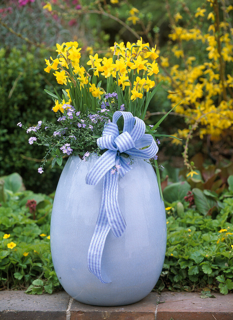 Light blue ceramic egg planted with flowers