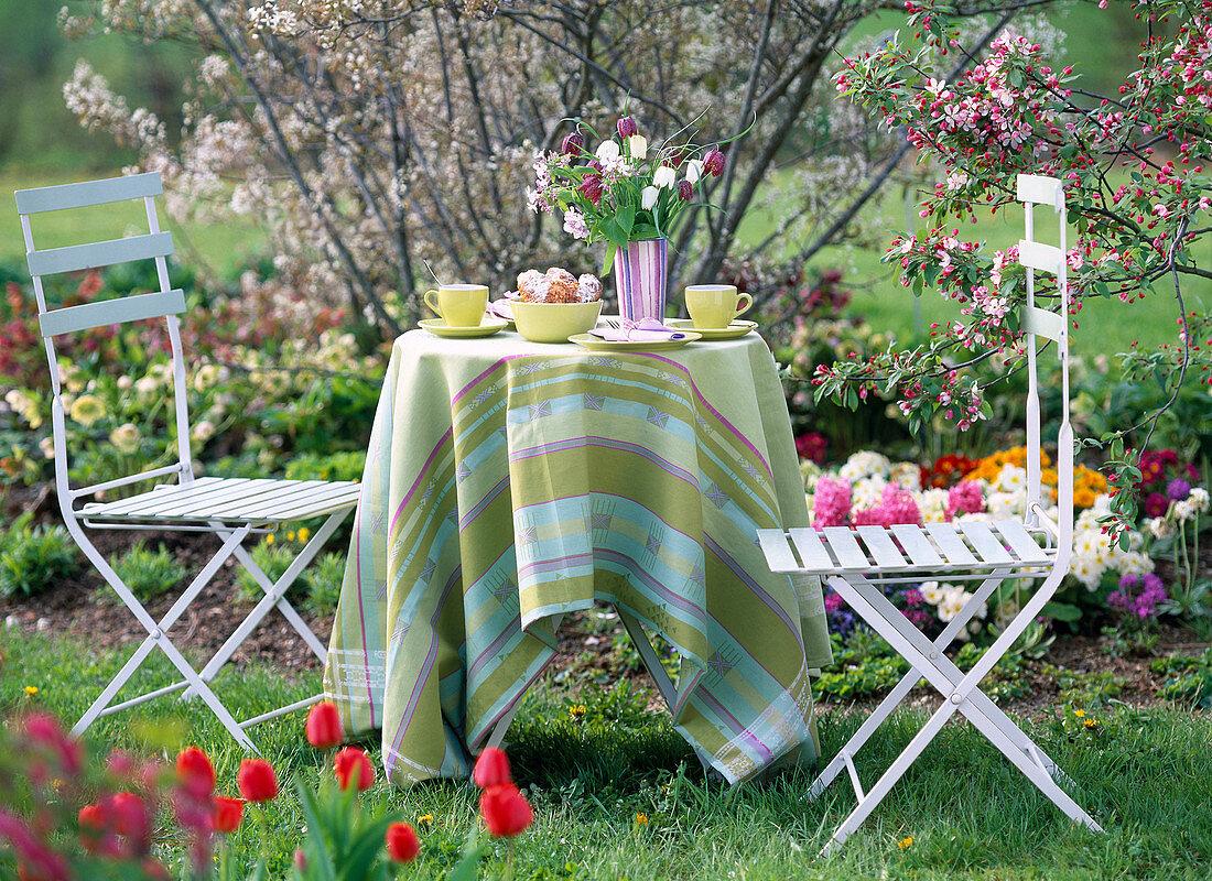 Seating group in the garden by the flower bed