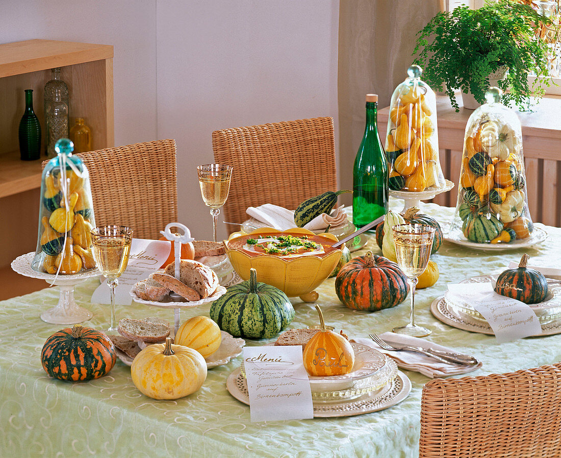 Table decoration with Cucurbita (pumpkin), pumpkins under glass bells, as place cards
